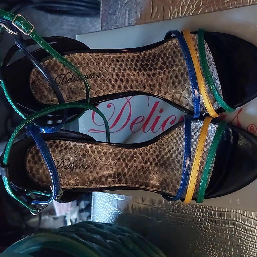 Strappy black patent faux leather with green,  blue, and yellow straps.